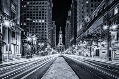 Illuminated city street at night