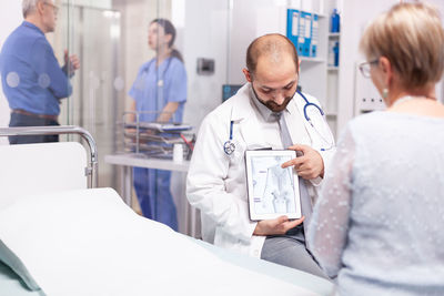 Female doctor examining patient in clinic