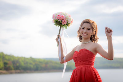 Portrait of a beautiful young woman against blue sky