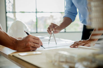 Close-up of business colleagues working in office