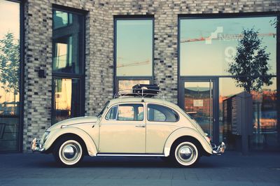 Car on street against buildings in city