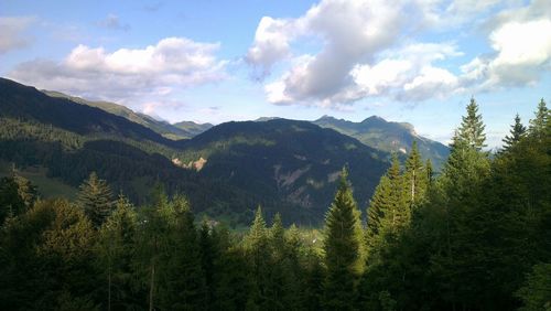 Scenic view of mountains against cloudy sky