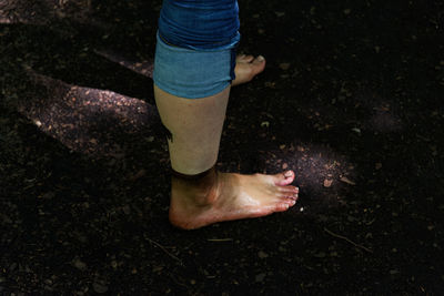 Low section of woman legs in mud