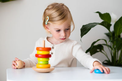 Close-up of girl playing with toys on table