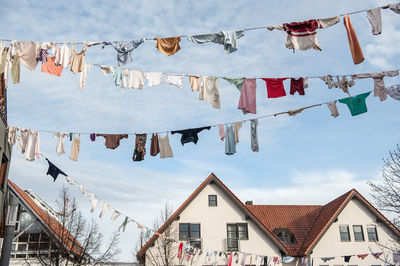 Low angle view of clothes drying on clothesline outside building