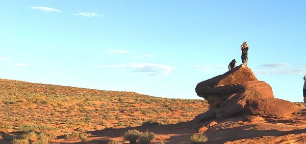 Statue on rock against sky