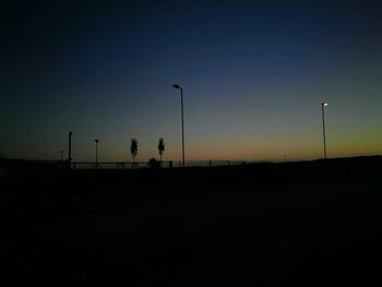 Silhouette landscape against clear blue sky