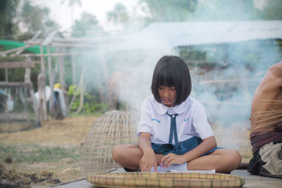 Portrait of a girl sitting outdoors