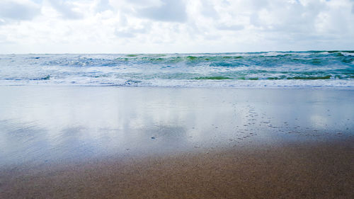 Scenic view of sea against cloudy sky