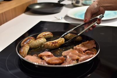 Close-up of man preparing food in plate