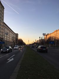 Traffic on road at sunset