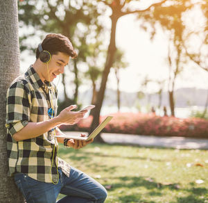 Young man using mobile phone outdoors