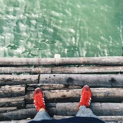 Low section of man relaxing in front of sea