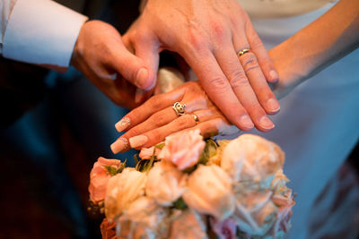 Midsection of couple holding hands