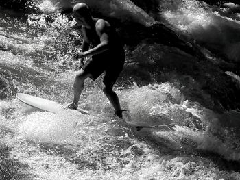 Full length of shirtless man in sea