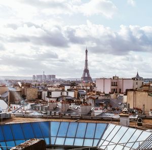 High angle view of buildings against cloudy sky