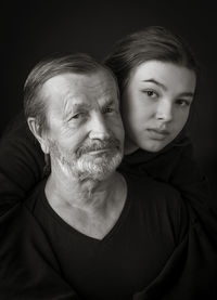 Elderly man and his granddaughter teen girl
