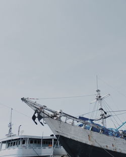 View of fishing boats in sea against sky