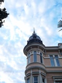 Low angle view of building against cloudy sky