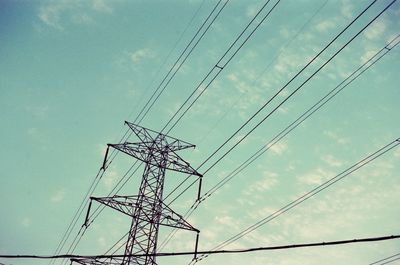 Low angle view of electricity pylon against sky