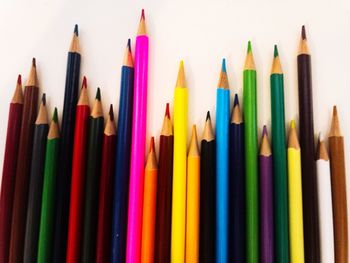 Close-up of colored pencils against white background