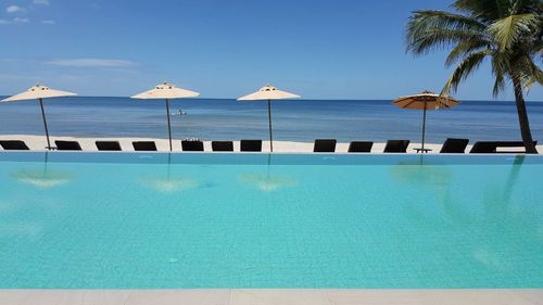 View of swimming pool against blue sky