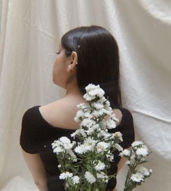 Midsection of woman with flower bouquet