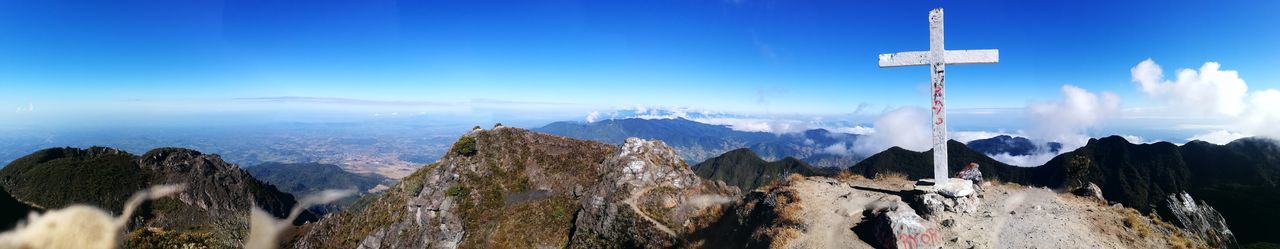 Panoramic view of trees and mountains against sky