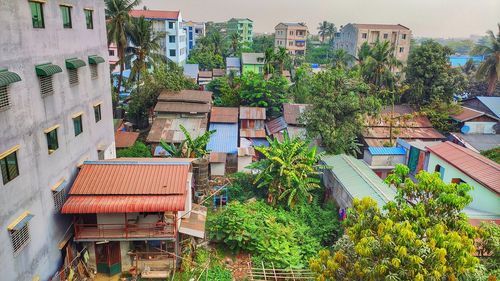 High angle view of trees and buildings in town