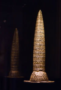 Close-up of illuminated metal against black background