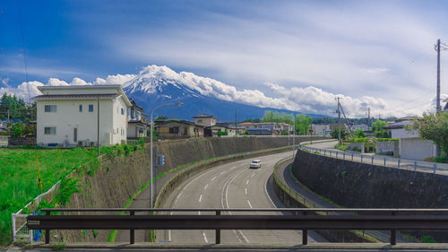 Road leading towards mountains against sky