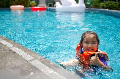 Portrait of boy swimming in pool