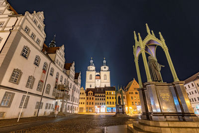 Low angle view of illuminated buildings at night