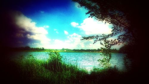 Scenic view of lake against cloudy sky