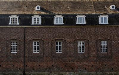 Normal classic house windows and roof windows in an old building.