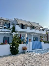 Houses by sea against clear sky