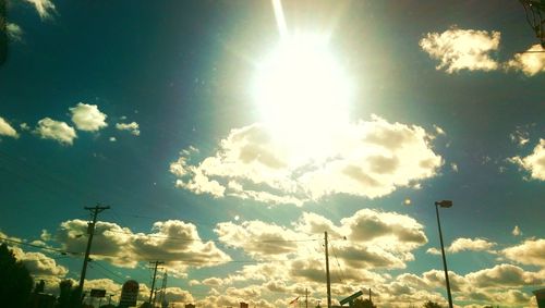 Low angle view of street light against cloudy sky