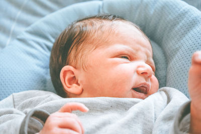 Cute baby lying on bed at home