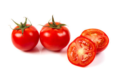 Close-up of tomatoes against white background