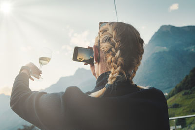 Portrait of man photographing through smart phone