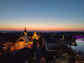 High angle view of illuminated buildings against sky at night