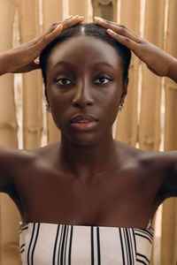 Close-up portrait of young woman standing at home