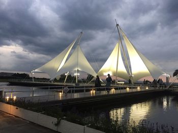 Bridge over river against sky at dusk