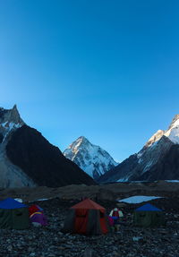 Scenic view of snowcapped mountains against clear blue sky
