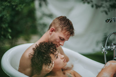 Couple in bathtub outdoors