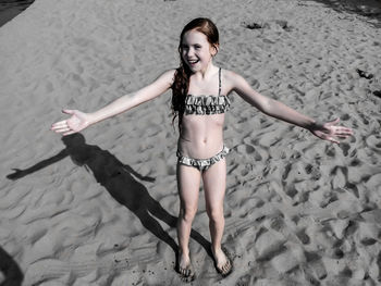 Portrait of young woman in bikini on beach
