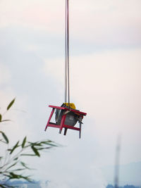 Low angle view of kite hanging against sky