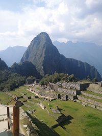 Scenic view of mountains against cloudy sky