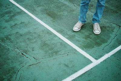 Low section of man standing on ground