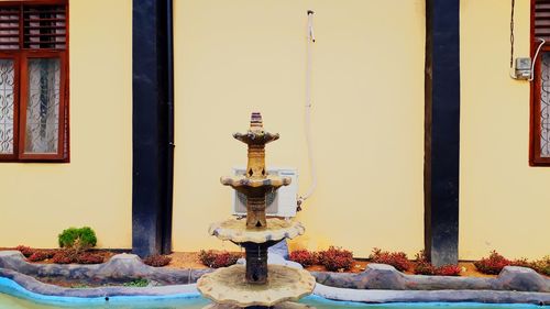 Close-up of metal on table against building